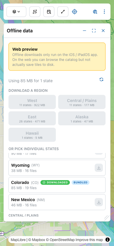 Per-state list with Wyoming (not downloaded, with download button), Colorado (with green DOWNLOADED pill and blue BUNDLED pill), and New Mexico (not downloaded).